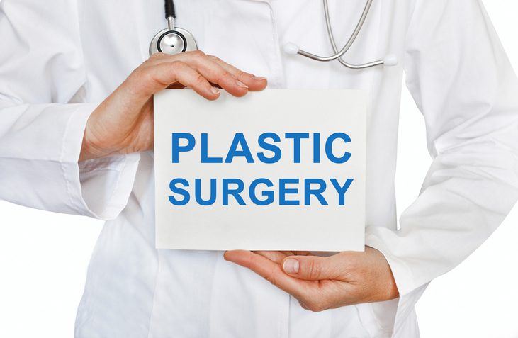 Plastic Surgery card in hands of Medical Doctor