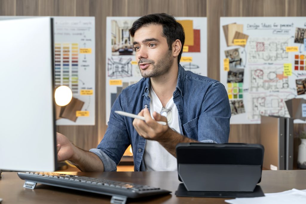 smart-adult-caucasian-designer-with-beard-sitting-working-table-desk-video-conference-with-clients-young-smart-creative-designer-working-home-home-isolation-quarantine-concept