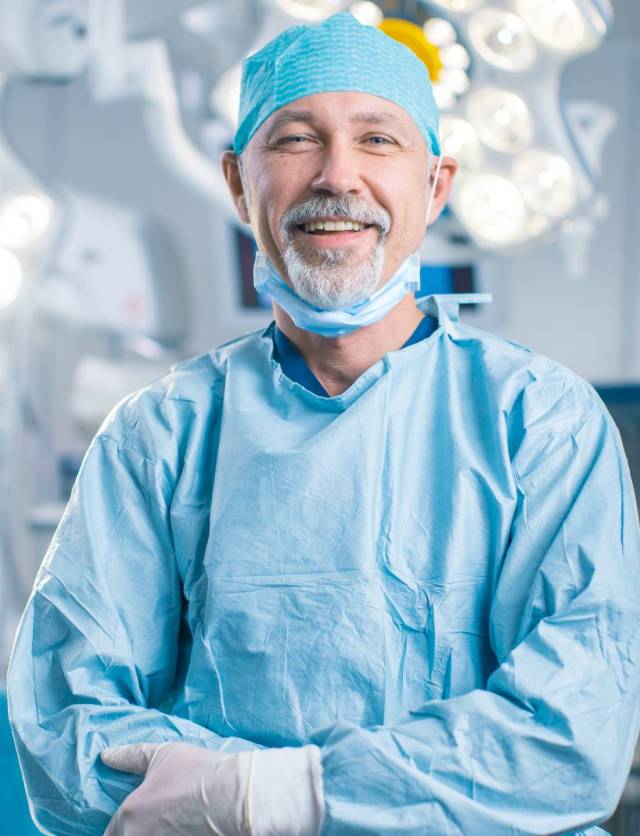 Portrait,Of,The,Professional,Surgeon,Looking,Into,Camera,And,Smiling